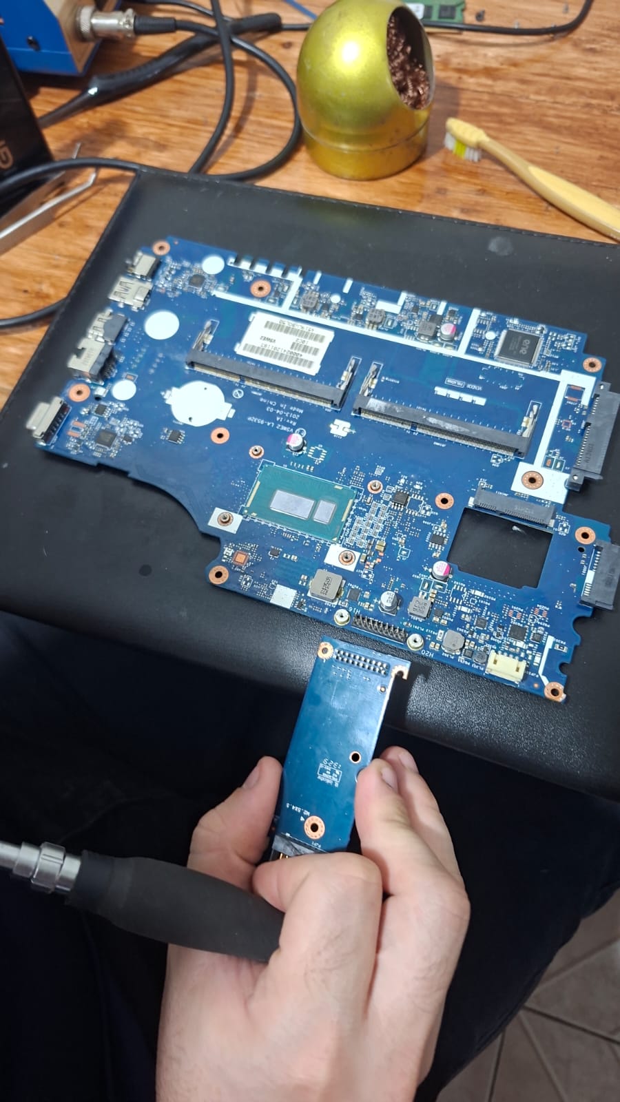Placa-mãe de notebook na bancada durante o reparo